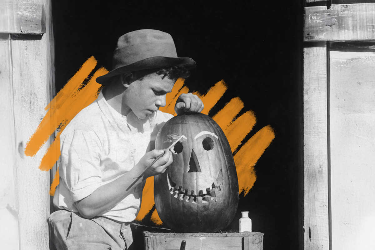 Boy painting Jack o Lantern, c 1910s