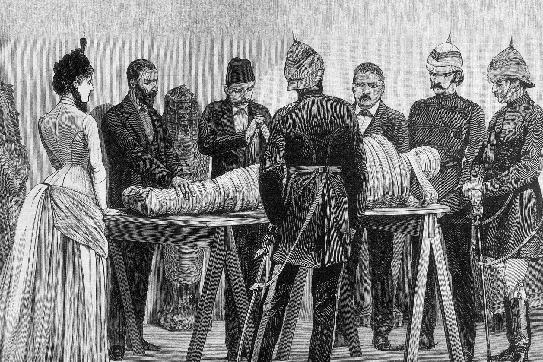 Spectators watch a mummy unwrapping