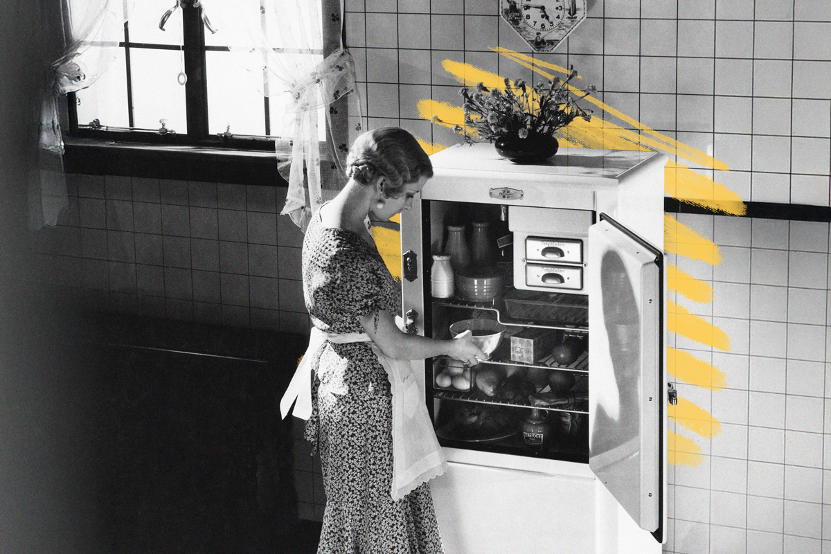 Woman using refrigerator, 1930s